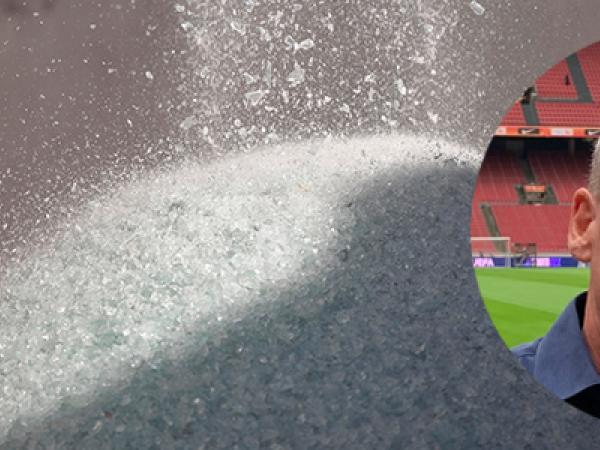 Krossat glas i bakgrunden, med en inklippt man framför