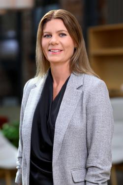 Kvinna med axellångt hår tittar in i kameran